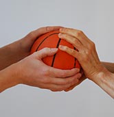 two hands grasping a ball